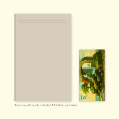 Little Big Thing V2 bookmark shown to scale beside a standard 5.5 x 8.5 inch paperback